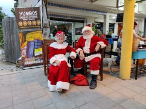 A gringo couple playing Santa and Mrs. Claus for the local children at Christmas. A gringo couple playing Santa and Mrs. Claus for the local children at Christmas.
